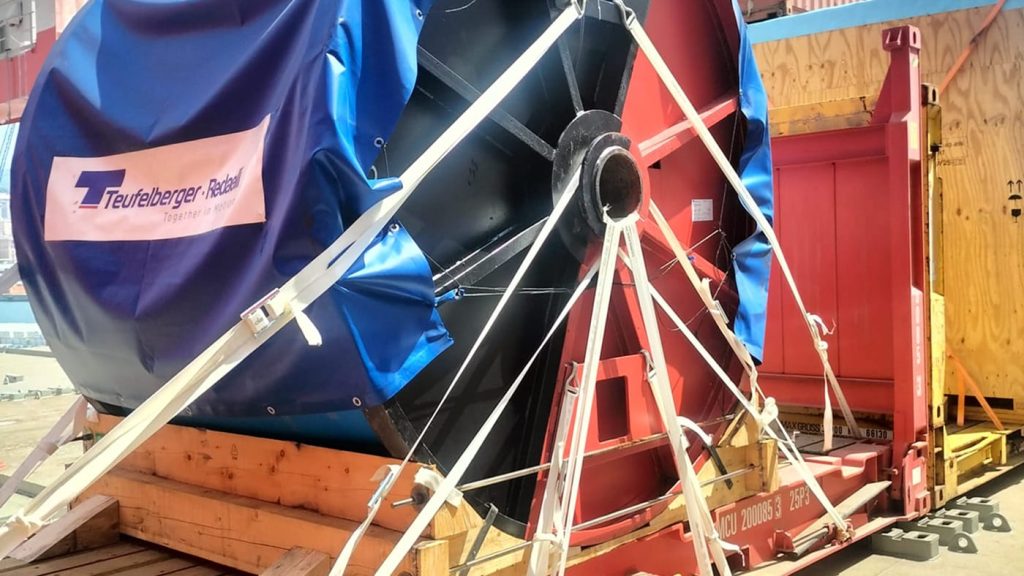 Close-up of a large Radaelli industrial reel unitized and secured on a shipping platform.