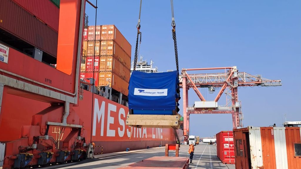 A crane hoisting a large Teufelberger-Redaelli reel over a Messina Line ship.