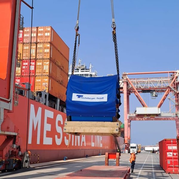 A crane hoisting a large Teufelberger-Redaelli reel over a Messina Line ship.
