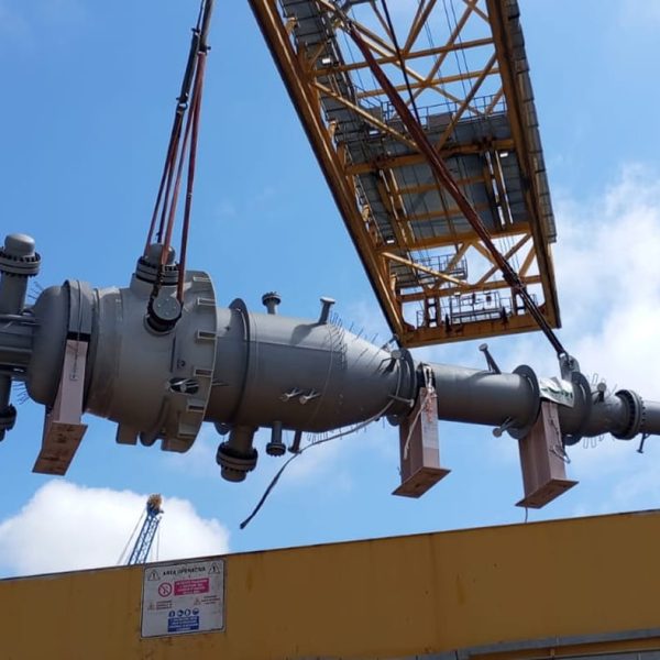 A massive industrial chiller being hoisted by a port crane over a Messina vessel.