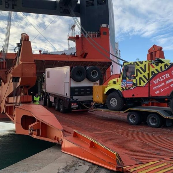 A Valtr Dakar racing truck driving up the massive stern ramp of the Jolly Palladio.