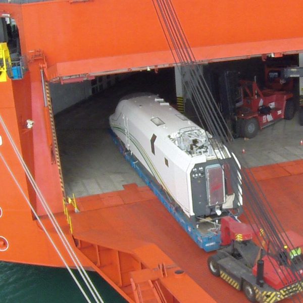 A Talgo locomotive being towed onto the Jolly Quarzo RO-RO vessel via the stern ramp.